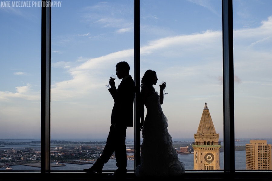 boston state room wedding photos couple silhouetted in huge windows overlooking boston harbor