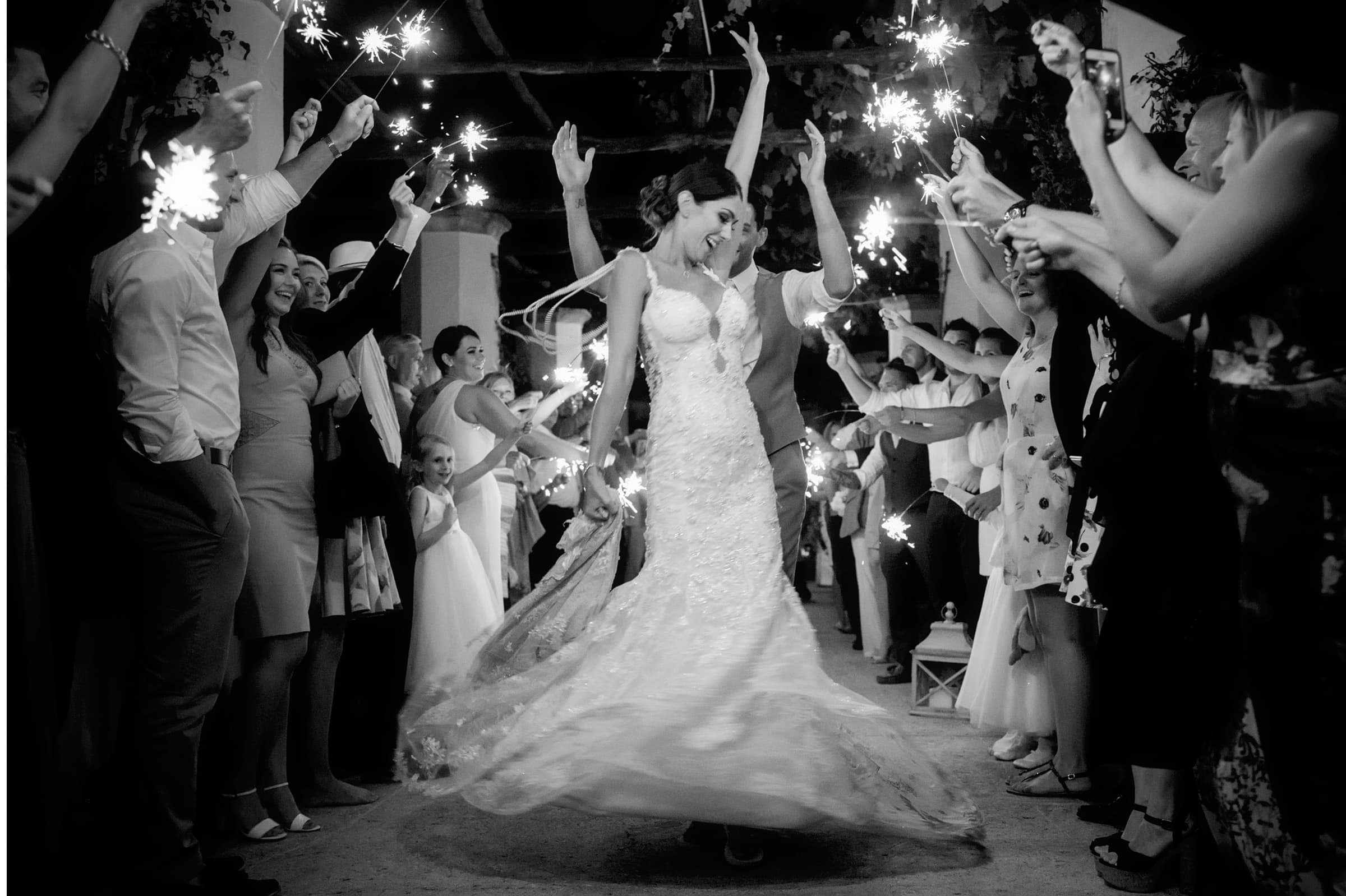 bride dances during sparkler exit at her destination wedding in italy