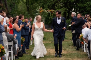 couple exiting outdoor ceremony at a connors center wedding