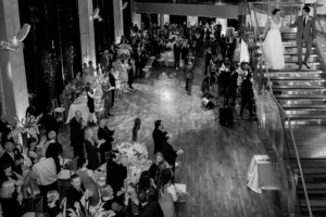 bride and groom enter their reception in the great room via staircase at this state room boston wedding