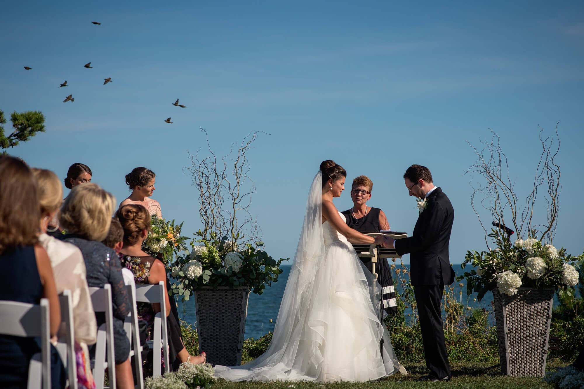 birds fly over during a Wianno club wedding ceremony on the lawn