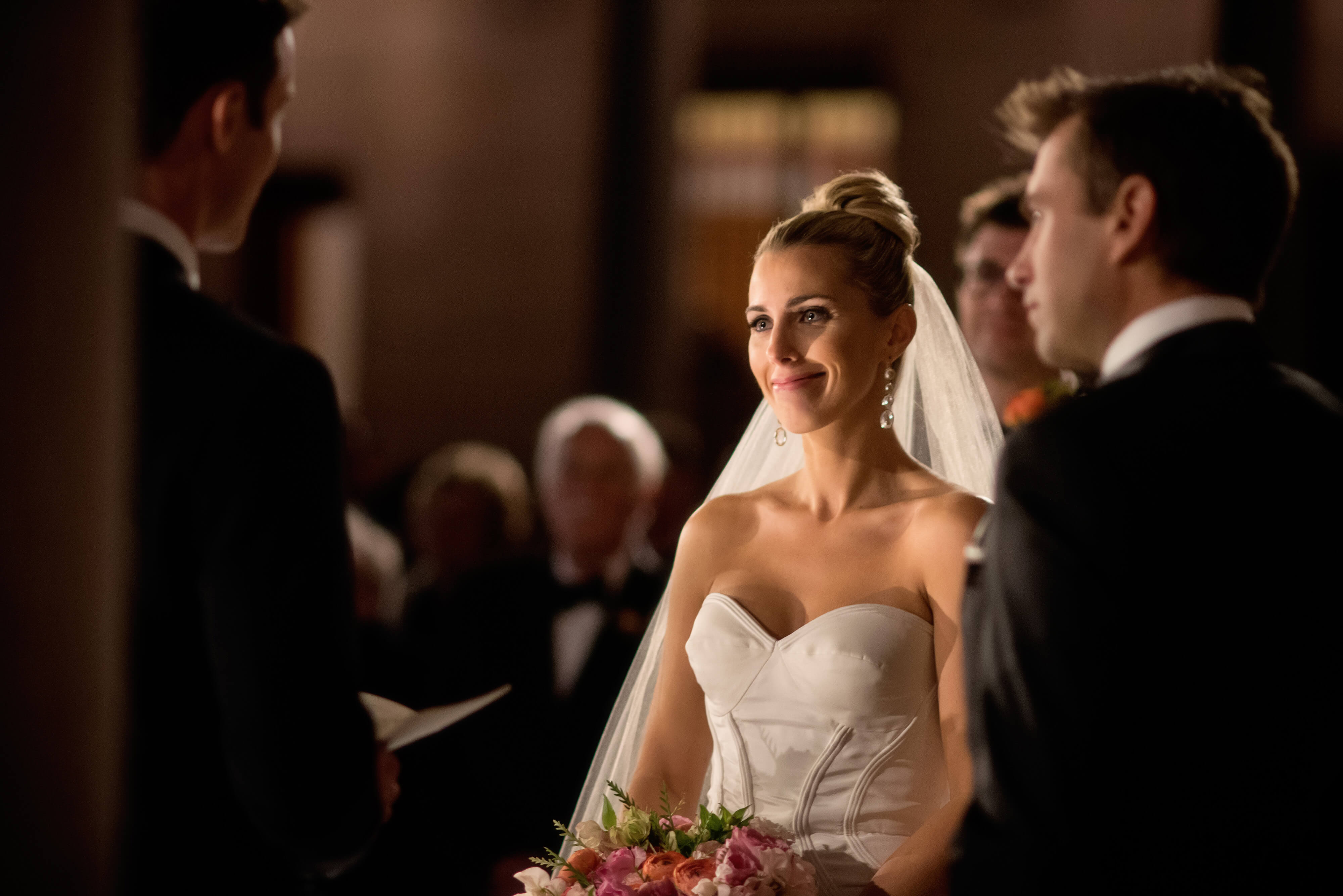 bride looking at groom during boston public library wedding in courtyard at night