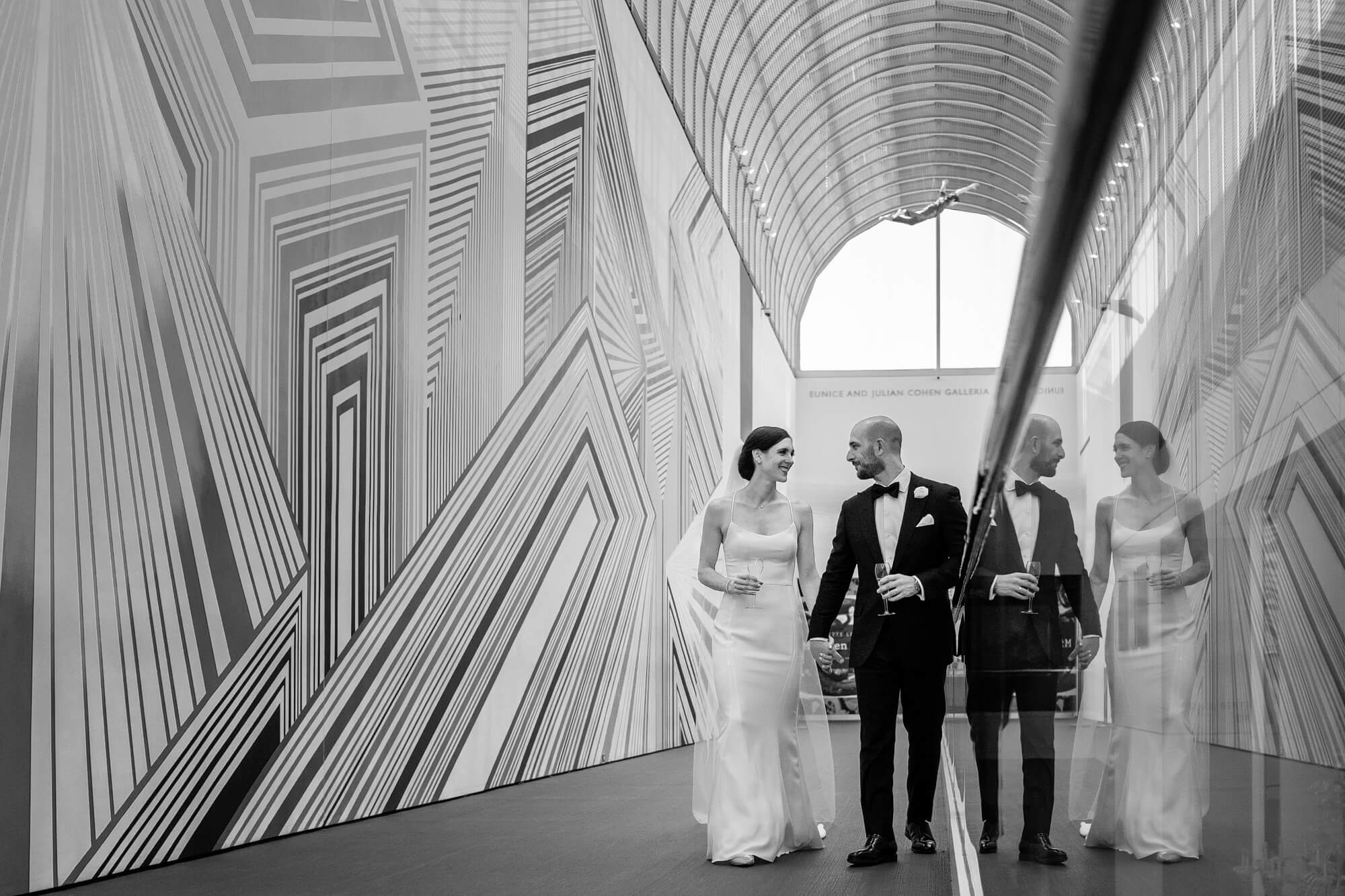 bride and groom walking through the museum of fine art wedding venue in boston