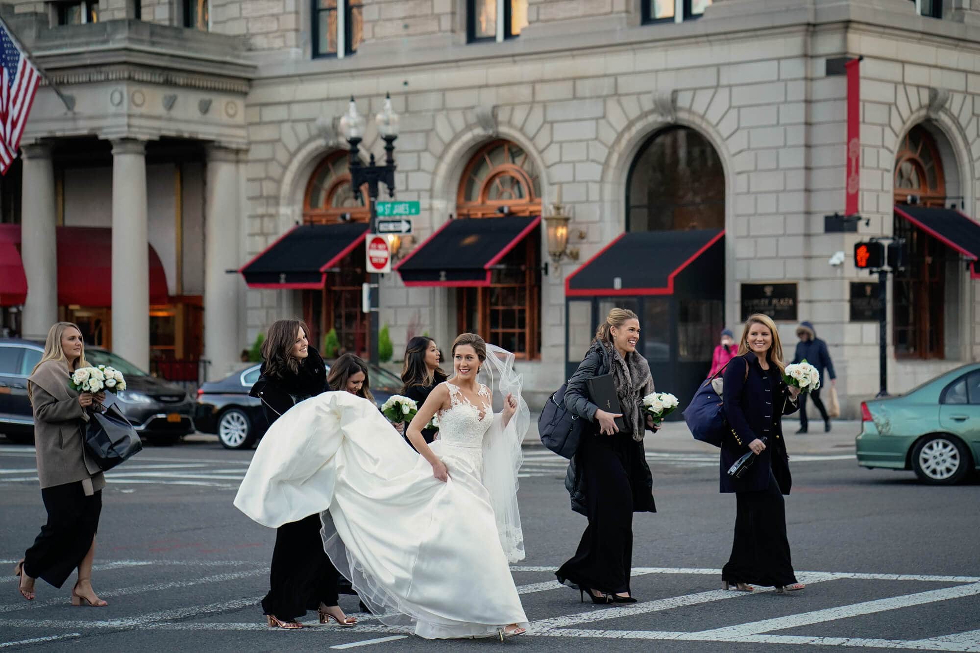 bride and bridesmaids cross the street in front of the Fairmont Copley to the Boston Public Library for the wedding