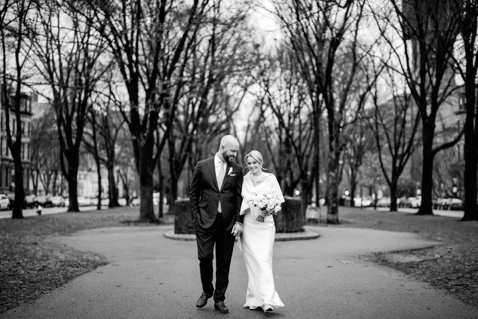 bride and groom walk through Comm Ave hand in hand before their intimate Newbury Boston wedding